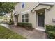 Townhouse entrance showcasing a well-kept walkway, tidy landscaping, and a gray front door at 7001 Interbay Blvd # 242, Tampa, FL 33616