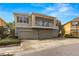 Three-story tan townhouse with stone accents and a second-story balcony overlooking three-car garages at 7001 Interbay Blvd # 242, Tampa, FL 33616
