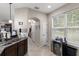 Bright hallway with tile flooring, leading to various rooms, and a beverage cooler at 7001 Interbay Blvd # 242, Tampa, FL 33616