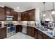 Modern kitchen with stainless steel appliances, dark cabinets, granite countertops, and ample lighting at 7001 Interbay Blvd # 242, Tampa, FL 33616