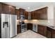 Well-equipped kitchen with stainless steel appliances, granite counters, and dark wood cabinets at 7001 Interbay Blvd # 242, Tampa, FL 33616
