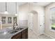 Kitchen island sink and counter with backyard view and white doors at 7001 Interbay Blvd # 242, Tampa, FL 33616