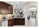 A cozy kitchen featuring dark wood cabinets, granite countertops, and stainless steel appliances at 7001 Interbay Blvd # 242, Tampa, FL 33616