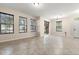 Open-concept living room with tile flooring, backyard views, and a chandelier at 7001 Interbay Blvd # 242, Tampa, FL 33616