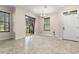 Open-concept living room with tile flooring, backyard views, and modern lighting at 7001 Interbay Blvd # 242, Tampa, FL 33616