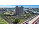 Aerial view showcasing a waterfront community with parking, tennis courts, and waterfront views at 7300 Sun Island S Dr # 1505, South Pasadena, FL 33707