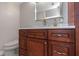Bathroom features custom wood cabinets, a stone countertop, and unique hardware at 7300 Sun Island S Dr # 1505, South Pasadena, FL 33707