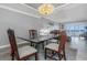 Well lit dining room area with glass table and chairs flowing into the living room at 7300 Sun Island S Dr # 1505, South Pasadena, FL 33707