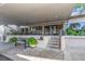 Inviting front entrance to the condo building, complete with seating and charming landscaping at 7300 Sun Island S Dr # 1505, South Pasadena, FL 33707