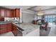 Condo kitchen with granite counters, island and view of the dining and living areas at 7300 Sun Island S Dr # 1505, South Pasadena, FL 33707