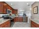 Modern kitchen with stainless steel appliances, granite countertops, and a convenient breakfast bar at 7300 Sun Island S Dr # 1505, South Pasadena, FL 33707