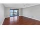 Living room with hardwood floors featuring a sliding glass door and a water view at 7300 Sun Island S Dr # 1505, South Pasadena, FL 33707