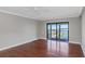 Hardwood floors in a sunny living room with a walkout patio overlooking the water at 7300 Sun Island S Dr # 1505, South Pasadena, FL 33707
