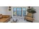 Well-lit living room featuring comfortable seating, stylish decor and sliding doors with a beautiful water view at 7300 Sun Island S Dr # 1505, South Pasadena, FL 33707