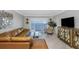 Bright living room with a comfortable leather sofa, stylish decor, and sliding doors to the outdoor view at 7300 Sun Island S Dr # 1505, South Pasadena, FL 33707