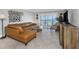 Inviting living room features a large sectional sofa, glass coffee table, and a view of the water at 7300 Sun Island S Dr # 1505, South Pasadena, FL 33707