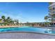 Expansive community pool surrounded by tropical landscaping and lounge seating at 7300 Sun Island S Dr # 1505, South Pasadena, FL 33707