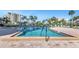 Community swimming pool with clear blue water and surrounding lounge chairs at 7300 Sun Island S Dr # 1505, South Pasadena, FL 33707