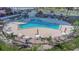 Aerial shot of a community pool with tables, lounge chairs, and lush landscaping at 7300 Sun Island S Dr # 1505, South Pasadena, FL 33707