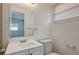A half bath, features a window, mirror, faucet, and white tiled wall at 7524 Tidewater Trl, Tampa, FL 33619
