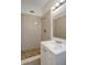 A full bathroom features white cabinets and light brown tiling for the shower at 7524 Tidewater Trl, Tampa, FL 33619