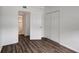 This bedroom features bright white walls, a closet, and dark brown wood flooring at 7524 Tidewater Trl, Tampa, FL 33619
