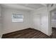 This bedroom features bright white walls, a closet, and dark brown wood flooring at 7524 Tidewater Trl, Tampa, FL 33619