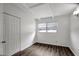 A simple bedroom with white walls and wood-look flooring at 7524 Tidewater Trl, Tampa, FL 33619