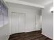 This bedroom features bright white walls, a closet, and dark brown wood flooring at 7524 Tidewater Trl, Tampa, FL 33619