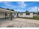 Angle view of house showing white exterior, carport, and blue front door at 7524 Tidewater Trl, Tampa, FL 33619