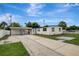 Charming white home with a covered carport and well-maintained landscaping at 7524 Tidewater Trl, Tampa, FL 33619