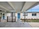 View of blue front door framed by a white home and covered carport at 7524 Tidewater Trl, Tampa, FL 33619