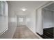 Bright hallway featuring white walls and light brown tiling at 7524 Tidewater Trl, Tampa, FL 33619