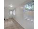 Bright hallway featuring white walls and light brown tiling at 7524 Tidewater Trl, Tampa, FL 33619