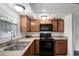 A kitchen with black appliances and brown cabinets at 7524 Tidewater Trl, Tampa, FL 33619