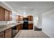 A kitchen with black appliances, tile floors, and brown cabinets at 7524 Tidewater Trl, Tampa, FL 33619