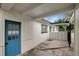 A view of a partially covered patio with access doors at 7524 Tidewater Trl, Tampa, FL 33619