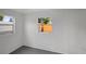 Neutral room featuring two windows and a gray floor at 7524 Tidewater Trl, Tampa, FL 33619