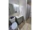 Cozy bathroom with a toilet, vanity, and shower with a curtain, offering a simple and functional design at 8341 41St N Ave, St Petersburg, FL 33709