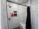 Modern bathroom featuring a glass-enclosed shower with a bench, stylish black fixtures, and tiled walls at 8341 41St N Ave, St Petersburg, FL 33709