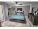 This cozy bedroom features a ceiling fan, ensuite bath and hardwood flooring at 8341 41St N Ave, St Petersburg, FL 33709
