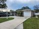 Charming single-story home with a well-maintained yard, driveway, and attached garage in a suburban setting at 8341 41St N Ave, St Petersburg, FL 33709