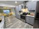 Modern kitchen with gray cabinets, stainless steel appliances, and an adjacent dining area for convenient meals at 8341 41St N Ave, St Petersburg, FL 33709
