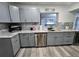 Stylish kitchen featuring gray cabinets, stainless steel appliances, and a sleek marble countertop at 8341 41St N Ave, St Petersburg, FL 33709