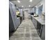 Modern galley kitchen with sleek gray cabinets, stainless steel appliances, and ample counter space at 8341 41St N Ave, St Petersburg, FL 33709