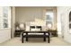 Bright bedroom featuring neutral tones, large windows, and stylish decor with a cozy, inviting atmosphere at 9583 Runaway Breeze Dr, Land O Lakes, FL 34637