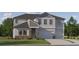 Inviting two-story home featuring a two-car garage, stone accents and charming landscaping at 9583 Runaway Breeze Dr, Land O Lakes, FL 34637