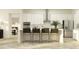 Modern kitchen with island seating, stainless steel appliances, and sleek white cabinets; perfect for cooking at 9583 Runaway Breeze Dr, Land O Lakes, FL 34637