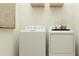 Functional laundry area featuring modern washer and dryer, providing convenient space for household chores at 9583 Runaway Breeze Dr, Land O Lakes, FL 34637
