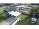 Aerial view of fenced backyard featuring a pool, patio, and shed at 1001 57Th N Ave, St Petersburg, FL 33703